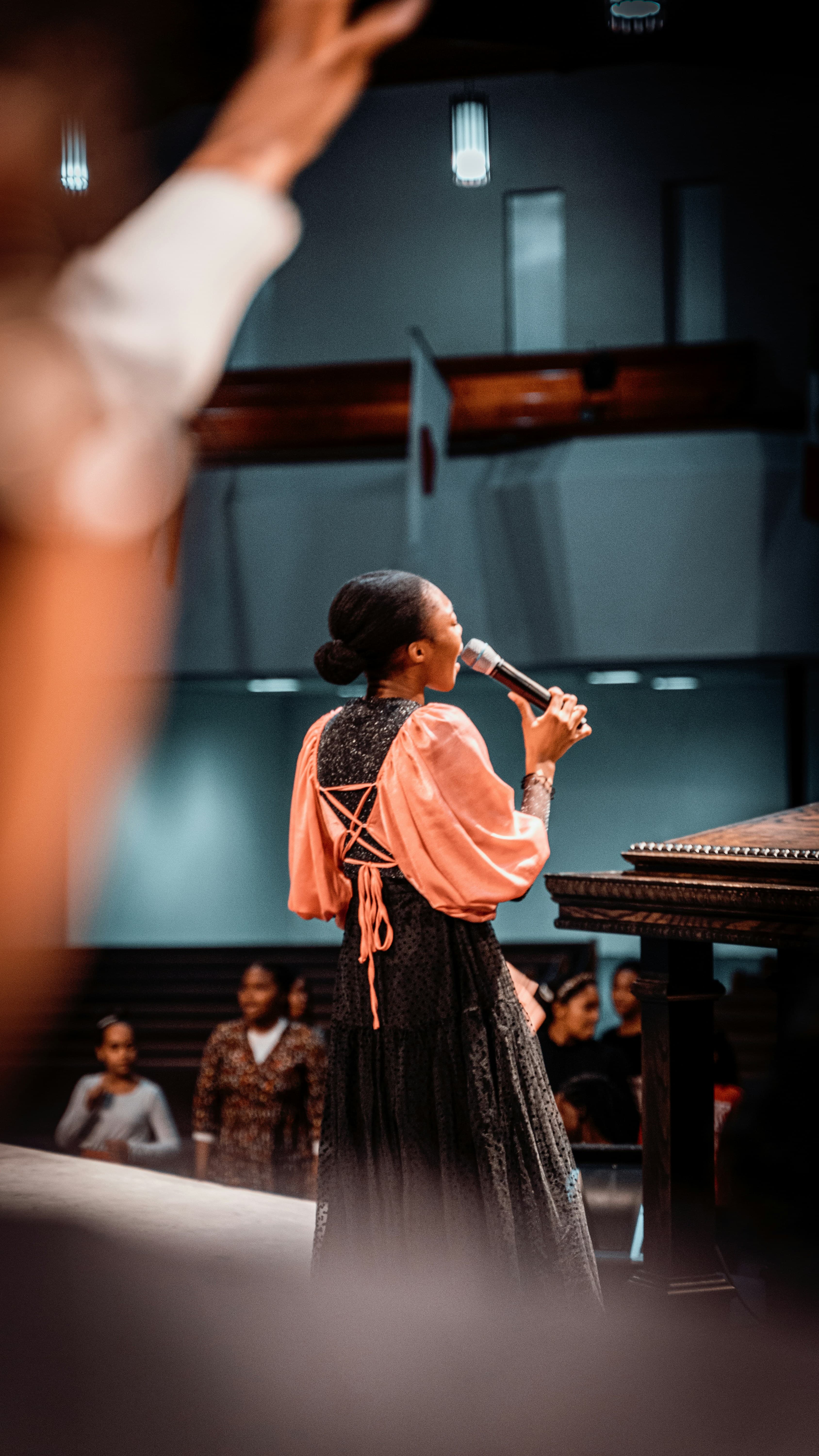 A worship leader singing into a microphone during a church service
